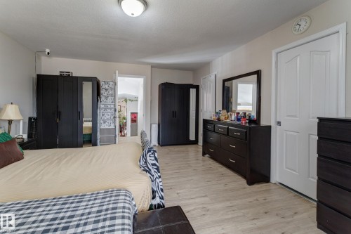 Wood-finish flooring with white trim and a ceiling-mounted light fixture - 3519 22 Street Nw, Edmonton, AB 