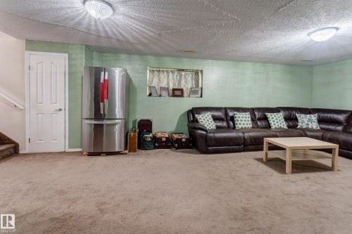 Recessed window, ceiling-mounted light fixtures, textured ceiling, light green wall paint, carpeted flooring - 3519 22 Street Nw, Edmonton, AB 
