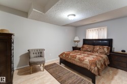 Neutral wall color, wood-finish flooring, recessed ceiling, and a built-in overhead light fixture - 