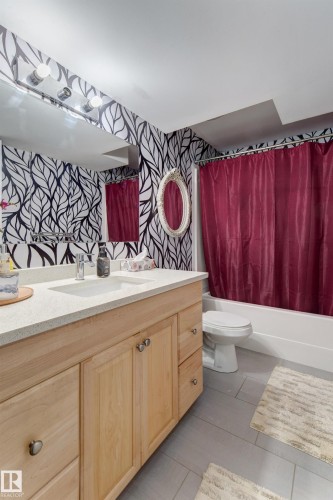 Light wood-finish vanity with a built-in sink and light-toned countertop - 3519 22 Street Nw, Edmonton, AB 