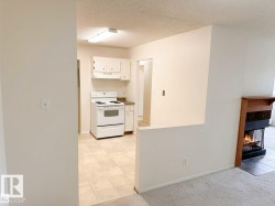 Kitchen featuring white cabinetry, a white electric range, and tiled flooring - 
