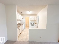Kitchen featuring white cabinetry, tile flooring, and a built-in electric range - 