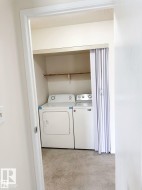Laundry closet with a built-in shelf and carpet flooring - 