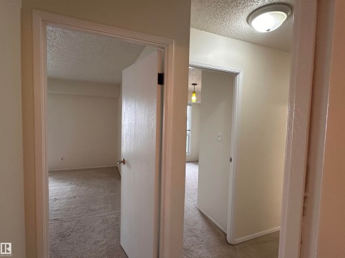 Neutral wall paint throughout, textured ceilings, and carpet flooring - #132 2703 79 St Nw, Edmonton, AB 