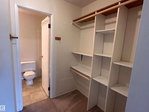 Custom closet shelving with integrated hanging rods - #132 2703 79 St Nw, Edmonton, AB 