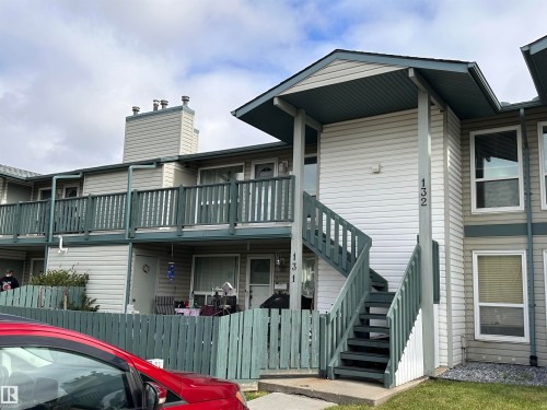 Two-story multi-unit structure with exterior siding, second-level balcony, and covered entry - #132 2703 79 St Nw, Edmonton, AB 