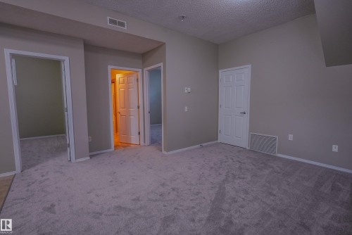 Neutral-toned walls complement plush carpeting - 122 142 Selkirk Place, Leduc, AB 