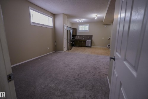Neutral-toned walls complement plush carpeting - 122 142 Selkirk Place, Leduc, AB 