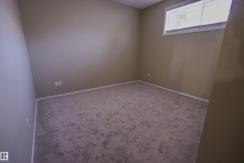 Neutral wall finish, window with white blinds, and light-colored carpeting - 122 142 Selkirk Place, Leduc, AB 