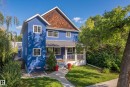 Two-story stucco exterior with white window frames and a prominent gable roof - 11006 64 Avenue Nw, Edmonton, AB 