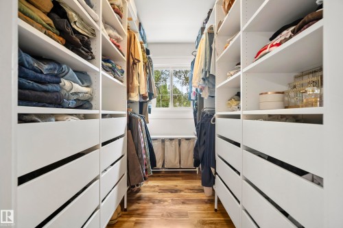 Custom closet system with integrated shelving, multiple hanging rods, and built-in drawers - 11006 64 Avenue Nw, Edmonton, AB 