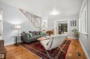 Hardwood flooring, white trim, staircase with wood handrail and black balusters, recessed lighting, and French doors - 11006 64 Avenue Nw, Edmonton, AB 