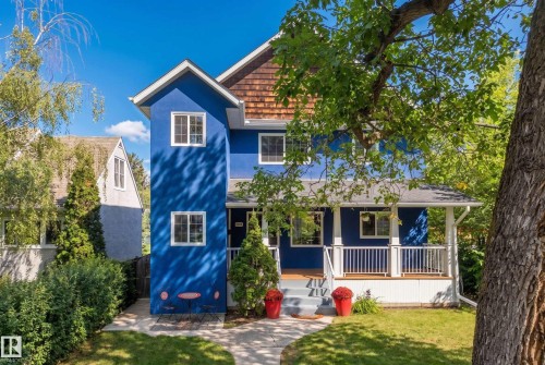 Blue exterior with white trim, covered front porch, and shingle roof - 11006 64 Avenue Nw, Edmonton, AB 