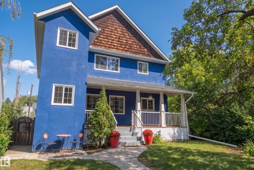 Blue stucco exterior with white trim windows - 11006 64 Avenue Nw, Edmonton, AB 