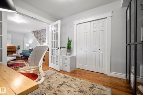 Hardwood flooring, French doors, two-panel bifold closet doors, and trim detailing - 11006 64 Avenue Nw, Edmonton, AB 