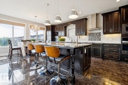 Ample cabinetry, s/s appliances, walk through pantry, granite counter tops with a large breakfast island - 