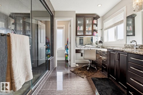 your own private retreat with a spa-inspired ensuite featuring a steam shower, soaker tub, makeup area, granite counter tops - 811 Albany Cove Nw, Edmonton, AB 