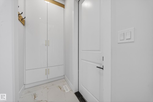 White paneled door with matte black hardware - 8737 Mayday Lane Sw, Edmonton, AB 