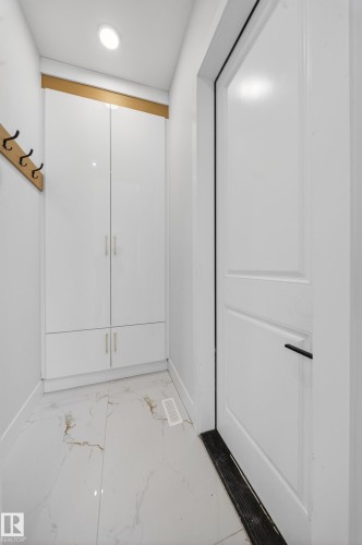 Integrated storage cabinetry, recessed lighting, and white panel door - 8737 Mayday Lane Sw, Edmonton, AB 
