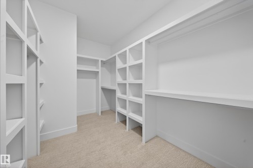 Built-in shelving, hanging rods, and neutral-toned carpeting - 8737 Mayday Lane Sw, Edmonton, AB 