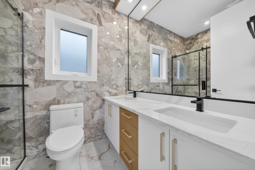 Dual vanity with integrated sinks, quartz countertop, and matte black fixtures - 8737 Mayday Lane Sw, Edmonton, AB 