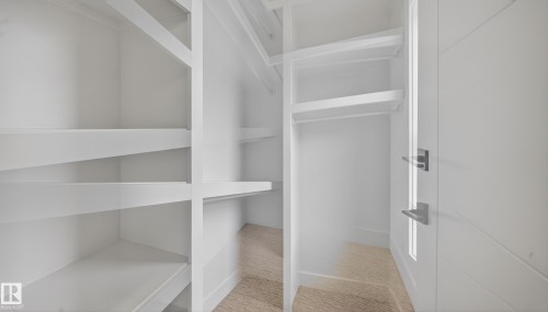 White built-in shelving, white walls, and wood-finish flooring - 8737 Mayday Lane Sw, Edmonton, AB 