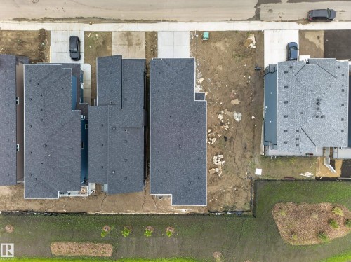 New construction properties featuring shingle roofs and concrete driveways - 8737 Mayday Lane Sw, Edmonton, AB 