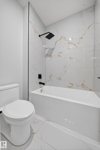 Full tile surround bathtub and shower with matte black fixtures - 8737 Mayday Lane Sw, Edmonton, AB 