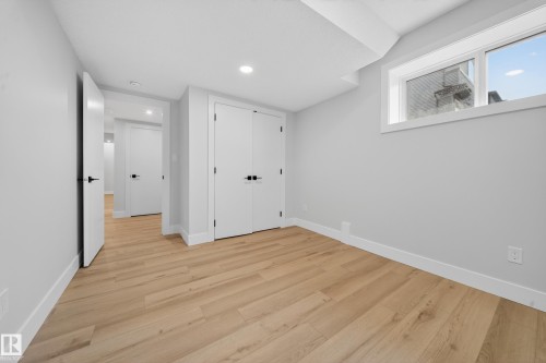 Recessed lighting, wood-finish flooring, white trim, and a double-door closet - 8737 Mayday Lane Sw, Edmonton, AB 