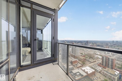 Private balcony with concrete flooring, glass railing, and urban landscape - #4007 10360 102 St Nw, Edmonton, AB 
