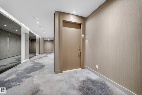 Textured wallpaper, recessed ceiling lighting, patterned carpet flooring, and a contemporary entry door - #4007 10360 102 St Nw, Edmonton, AB 