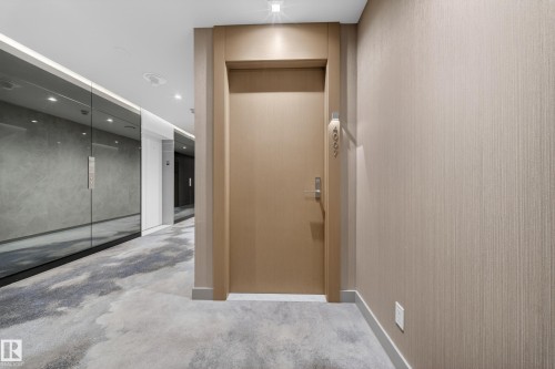 Entry door with satin nickel hardware, recessed lighting, and textured wall covering - #4007 10360 102 St Nw, Edmonton, AB 