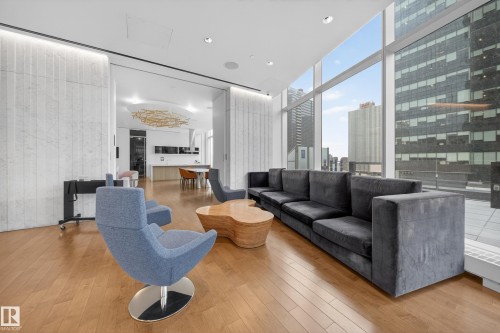 Hardwood flooring throughout, tall window wall, recessed lighting, and white textured wall panels - #4007 10360 102 St Nw, Edmonton, AB 