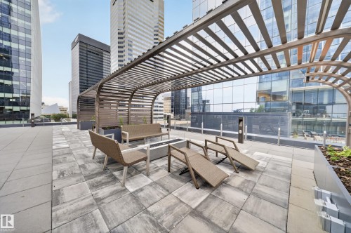 Rooftop patio featuring a slatted pergola, paver flooring, and integrated planters - #4007 10360 102 St Nw, Edmonton, AB 