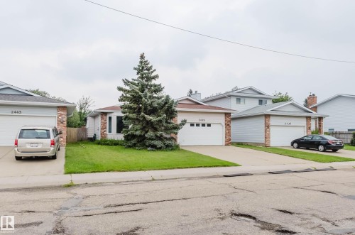 Single-story residence featuring a prominent evergreen tree in the front yard - 2439 112 Street Nw, Edmonton, AB - Outdoor With Facade