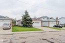 Single-story residence featuring a prominent evergreen tree in the front yard - 2439 112 Street Nw, Edmonton, AB  - Outdoor With Facade 