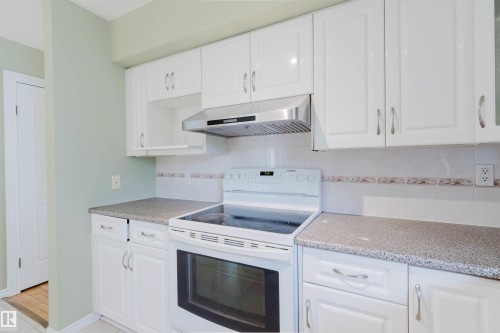 Kitchen featuring white cabinetry and light-toned countertops - 2439 112 Street Nw, Edmonton, AB - Indoor Photo Showing Kitchen