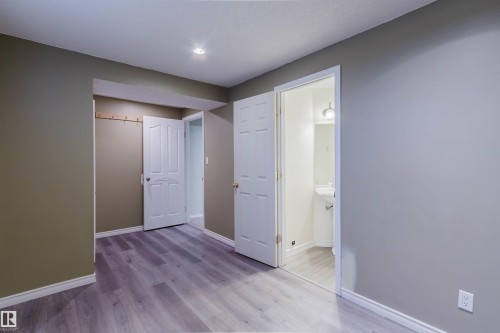 Interior space featuring wood-finish flooring, recessed ceiling lighting, and a neutral wall palette - 2439 112 Street Nw, Edmonton, AB - Indoor Photo Showing Other Room