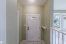 Entryway featuring a white door with decorative glass inserts, recessed lighting, and tile flooring - 2439 112 Street Nw, Edmonton, AB  - Indoor Photo Showing Other Room 