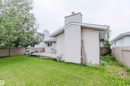Expansive grassy yard with wood fencing and a generous wood deck - 2439 112 Street Nw, Edmonton, AB - Outdoor With Exterior