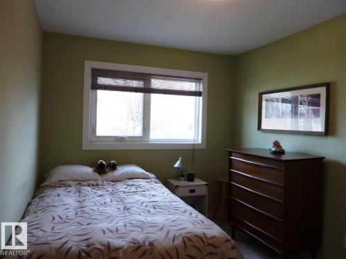Light green painted walls - 2439 112 Street Nw, Edmonton, AB - Indoor Photo Showing Bedroom
