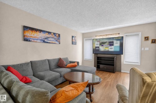 Wood-finish flooring, neutral wall color, and white window frames - 21312 48 Avenue Nw, Edmonton, AB 