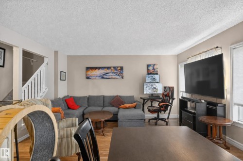 Wood-finish flooring, neutral wall tones, and white trim throughout - 21312 48 Avenue Nw, Edmonton, AB 