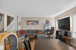 Wood-finish flooring, neutral wall tones, and white trim throughout - 