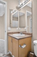 Wood-finish vanity with an integrated sink and laminate countertop - 
