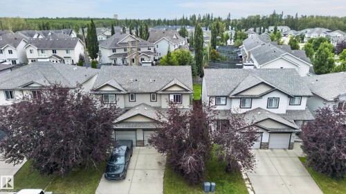 Two-story residential architecture with light-toned siding and dark trim - 21312 48 Avenue Nw, Edmonton, AB 