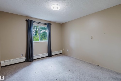 Neutral-toned walls complement the gray carpeting - #316 17109 67 Av Nw, Edmonton, AB 