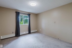 Neutral-toned walls complement the gray carpeting - 