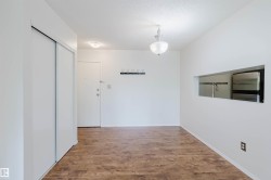 Hardwood-finish flooring, built-in coat rack, translucent glass chandelier, pass-through window, and sliding wardrobe doors - 