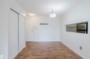 Hardwood-finish flooring, built-in coat rack, translucent glass chandelier, pass-through window, and sliding wardrobe doors - #316 17109 67 Av Nw, Edmonton, AB 